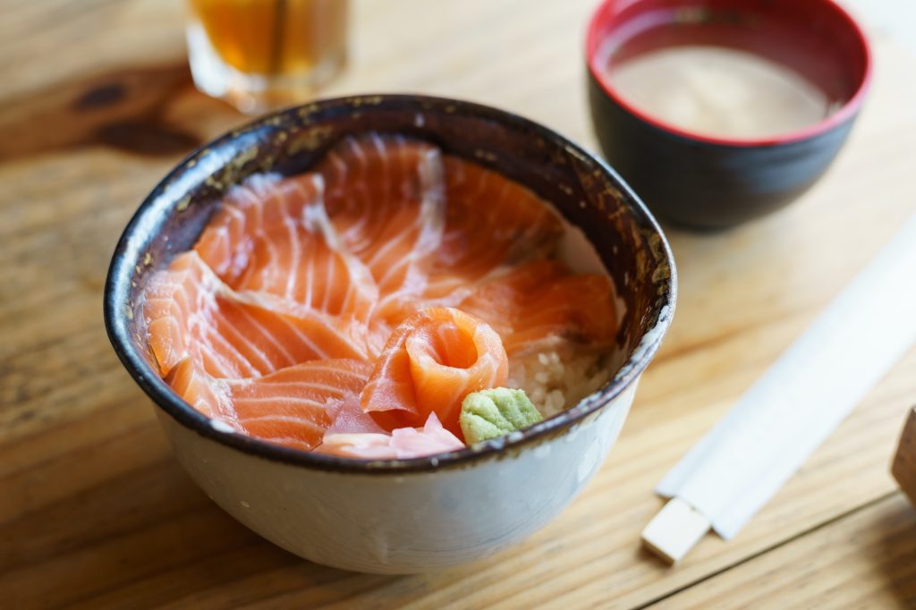 Salmon Donburi serve with miso soup on wooden table